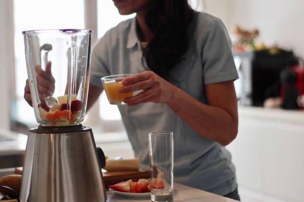 A woman making a smoothie.
